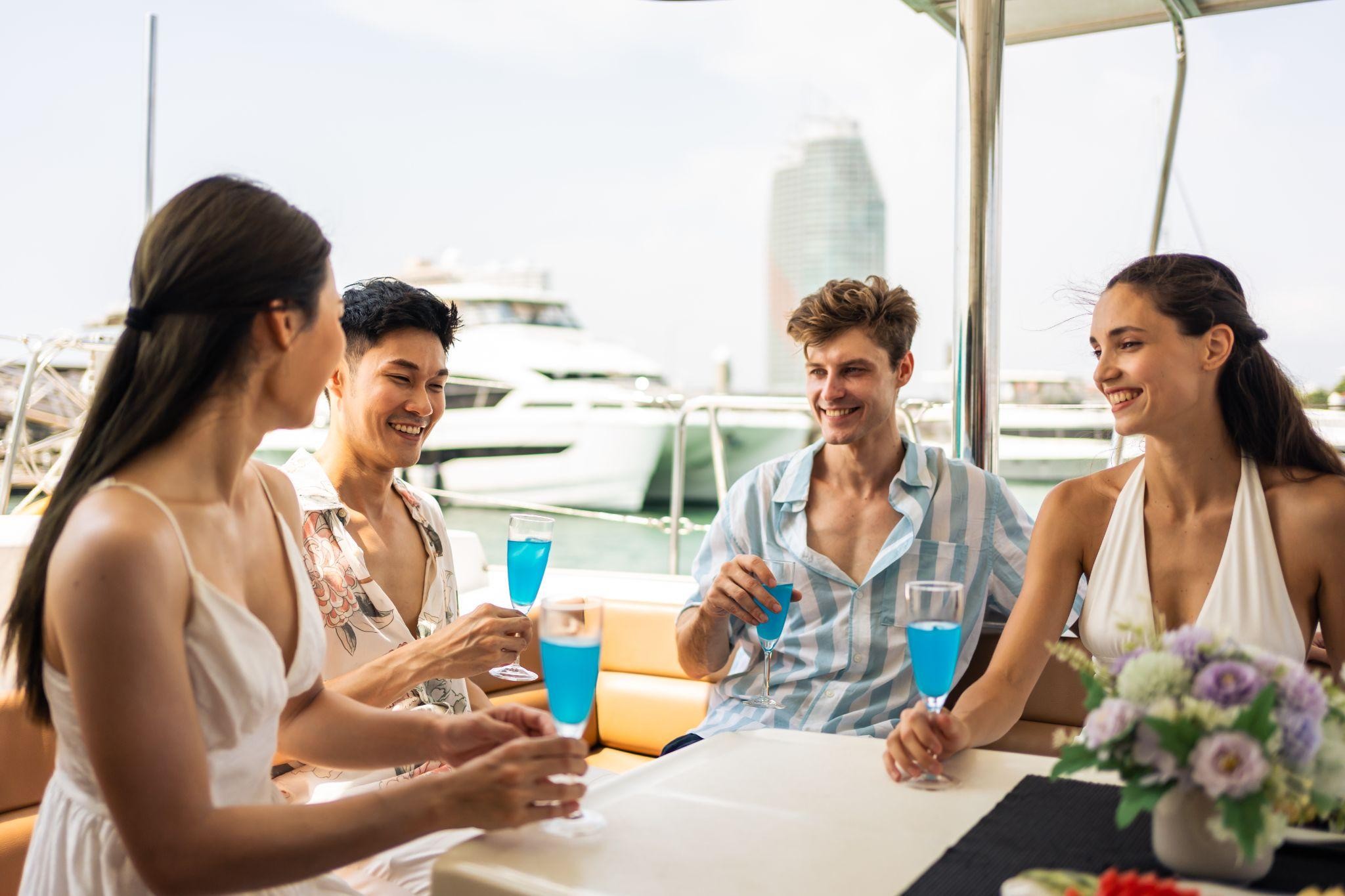 Diverse friends enjoying drinks on a yacht in Palm Beach, highlighting the social side of boating club membership and affordable boat club prices.