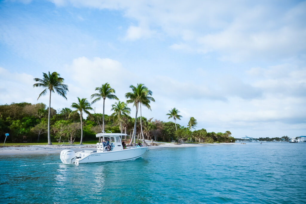 A boat gliding on clear blue water. Holiday boating gifts.