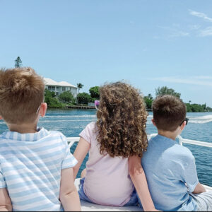 A group of young kids on a boat, celebrating thanksgiving on a boat